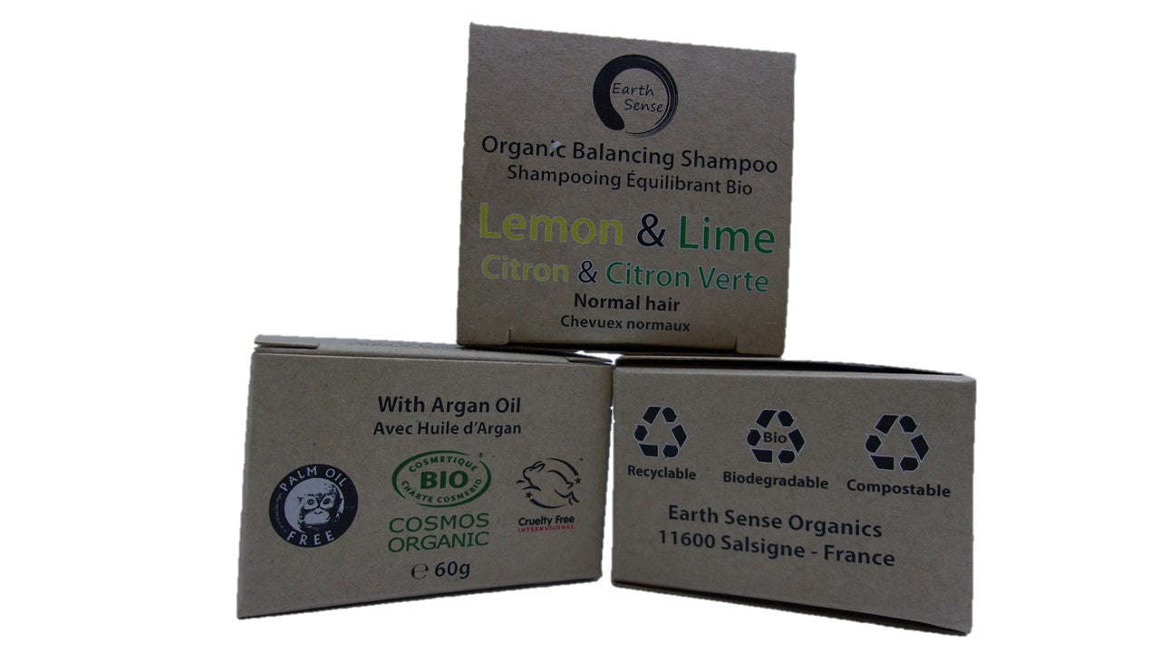 Three boxes of Organic Balancing Shampoo with Lemon & Lime scent on a white background